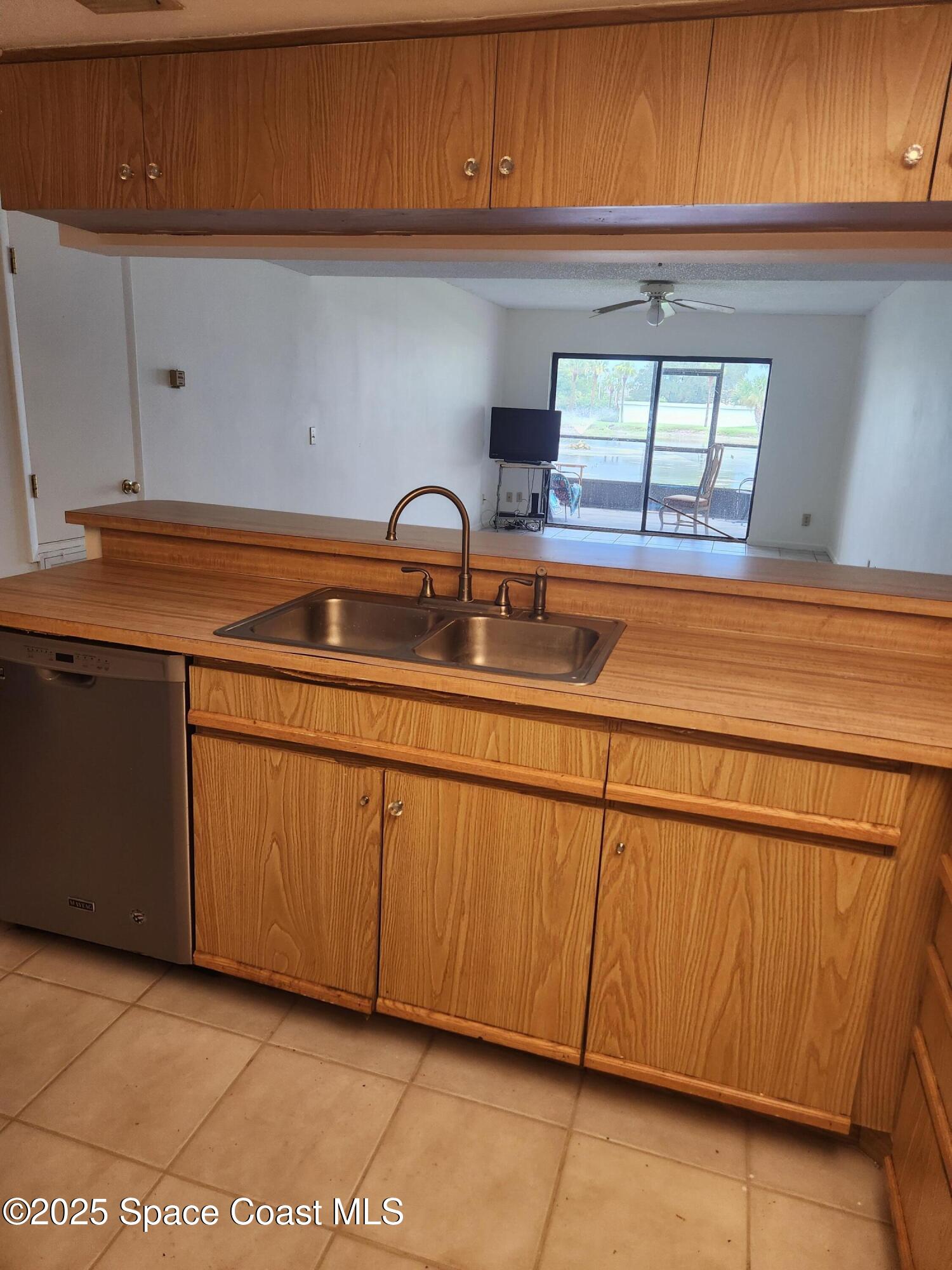 3165 North Atlantic Avenue, Unit C105 Cocoa Beach, FL 32931 - Photo 6 of 10 a kitchen with a sink and cabinets