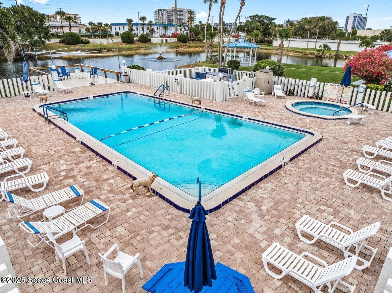 3165 North Atlantic Avenue, Unit C105 Cocoa Beach, FL 32931 - Photo 8 of 10 a view of a swimming pool with a patio