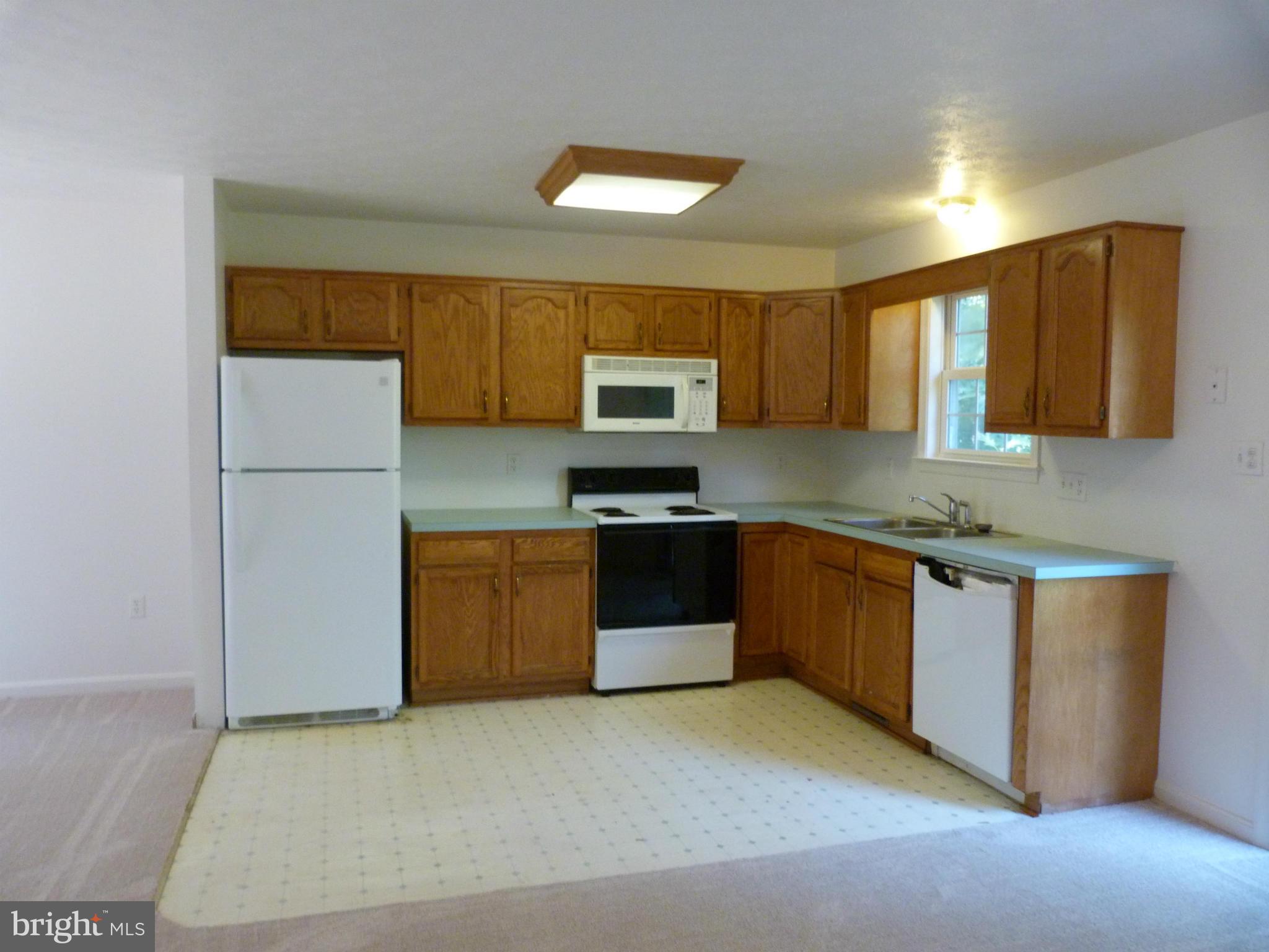 235 Freeze Road Linden, VA 22642 - Photo 5 of 10 a kitchen with granite countertop a refrigerator and a stove