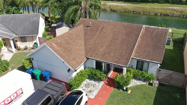an aerial view of a residential houses with yard