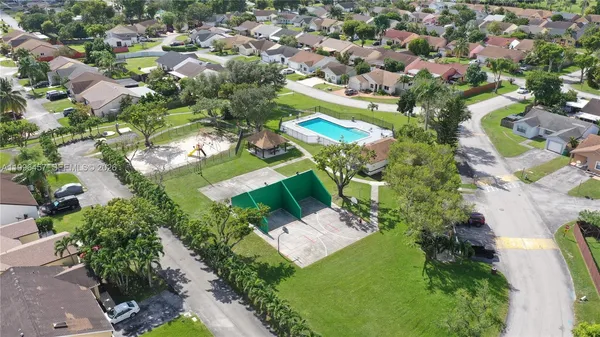 an aerial view of a house with a garden and lake view