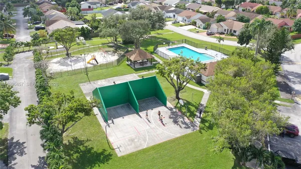 an aerial view of a house with a garden and swimming pool