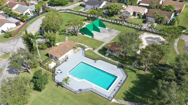 an aerial view of multiple houses with yard