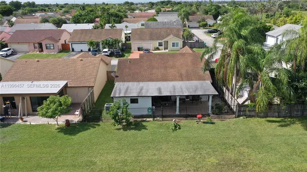 an aerial view of a house with a yard and lake view
