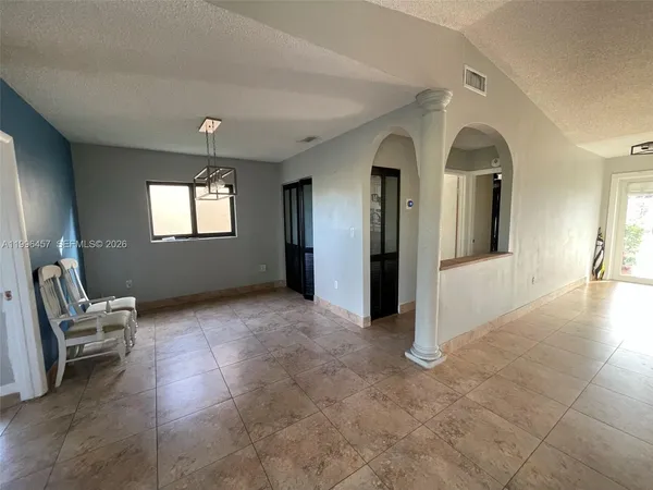 a view of a livingroom with furniture and staircase