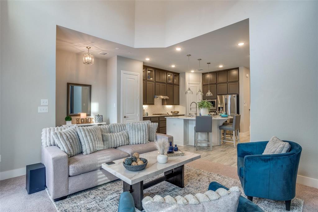 Living room featuring recessed lighting and a towering ceiling