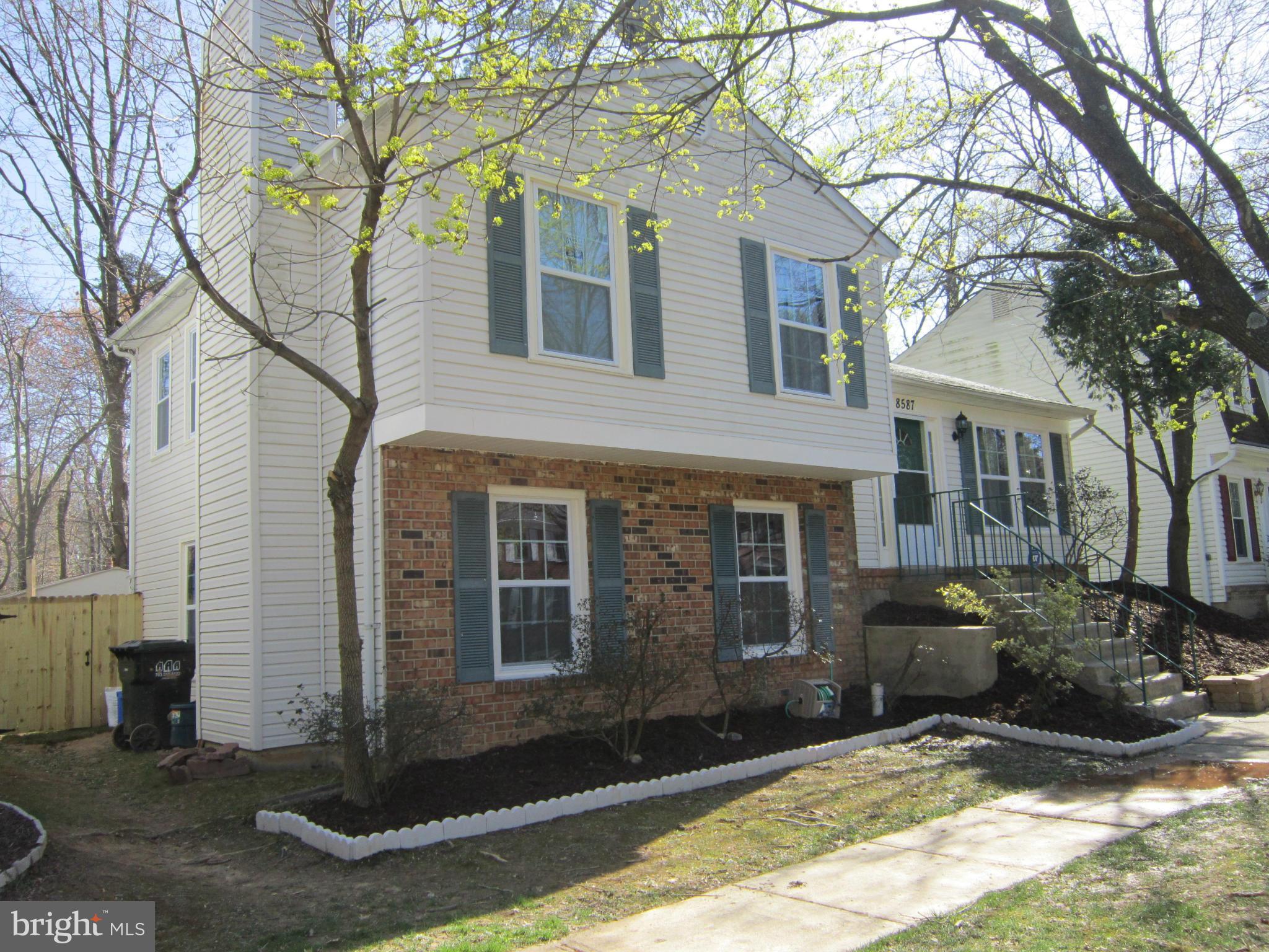8587 Tyrolean Way Springfield, VA 22153 - Photo 2 of 30 a front view of a house with a yard