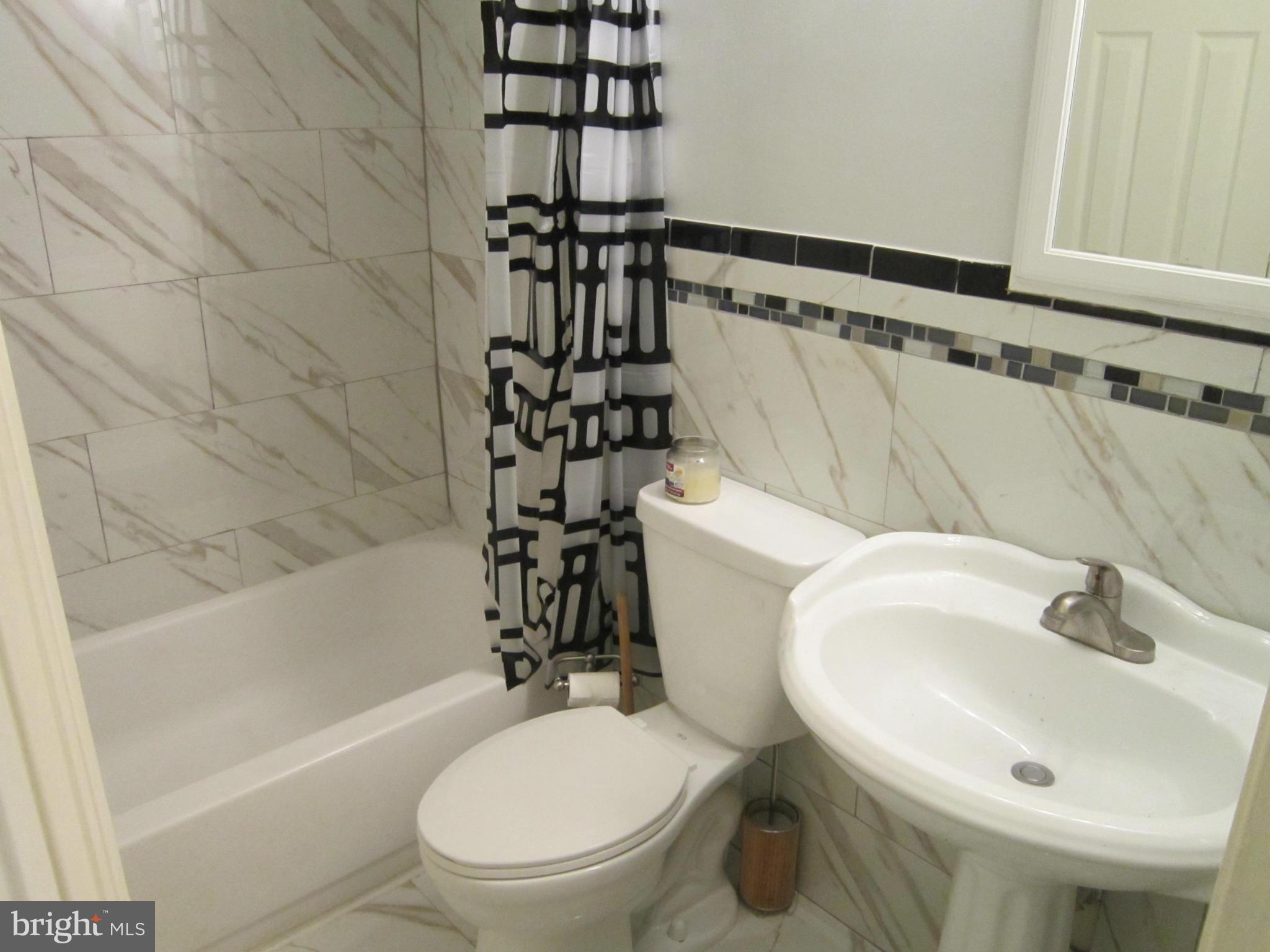 8587 Tyrolean Way Springfield, VA 22153 - Photo 13 of 30 a white toilet sitting next to a bathroom sink