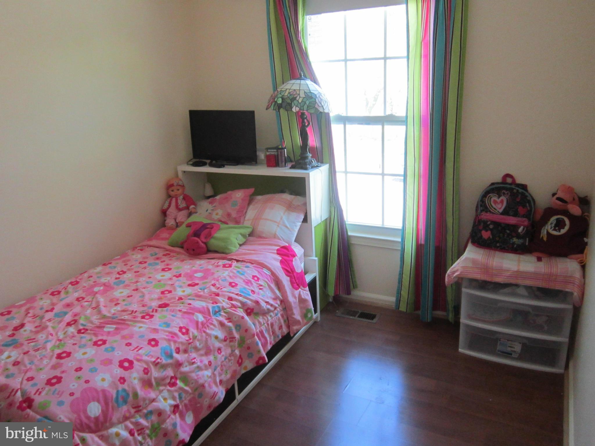 8587 Tyrolean Way Springfield, VA 22153 - Photo 14 of 30 a bedroom with a bed and wooden floor