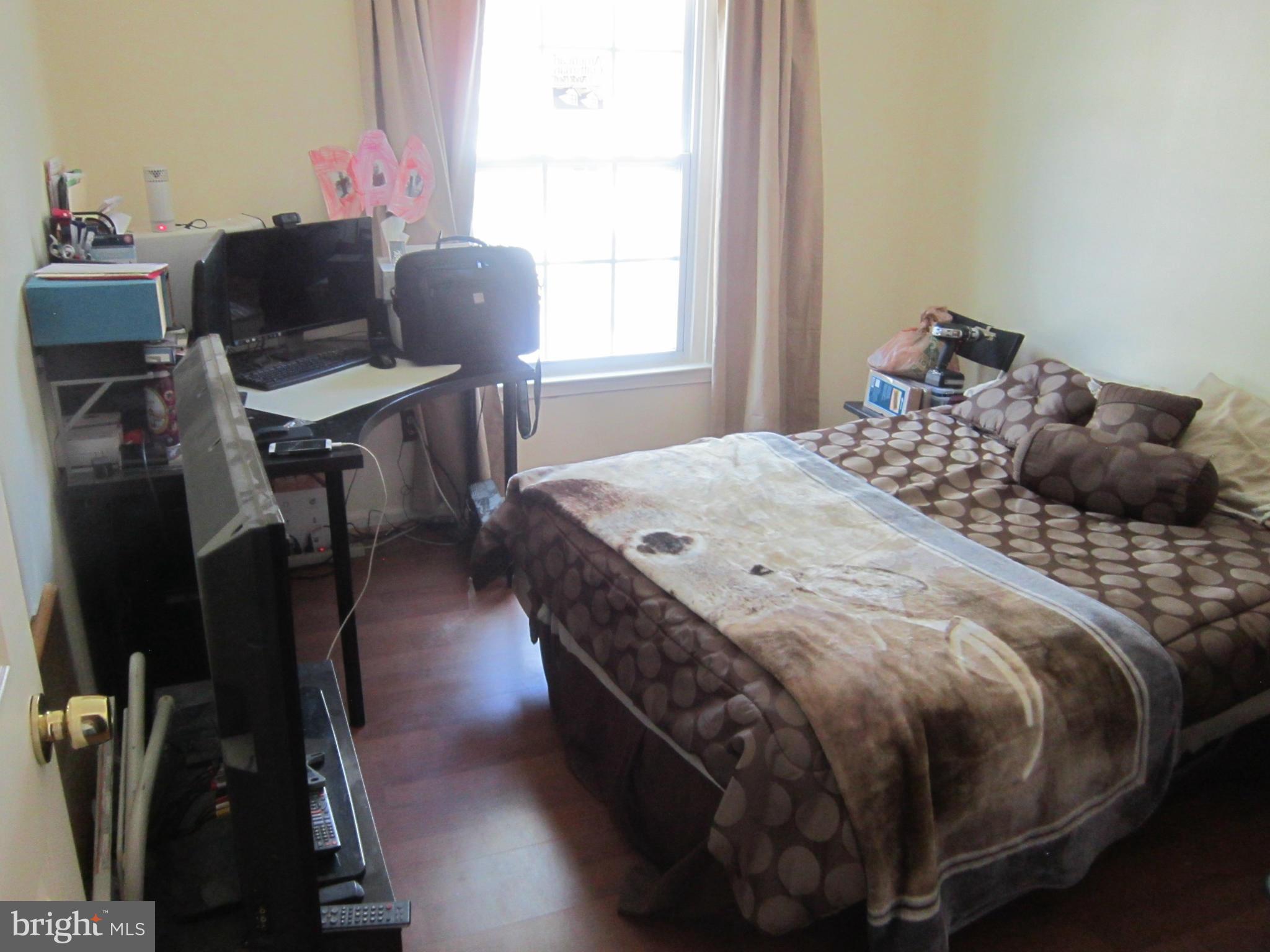 8587 Tyrolean Way Springfield, VA 22153 - Photo 16 of 30 a bedroom with a bed and a desk