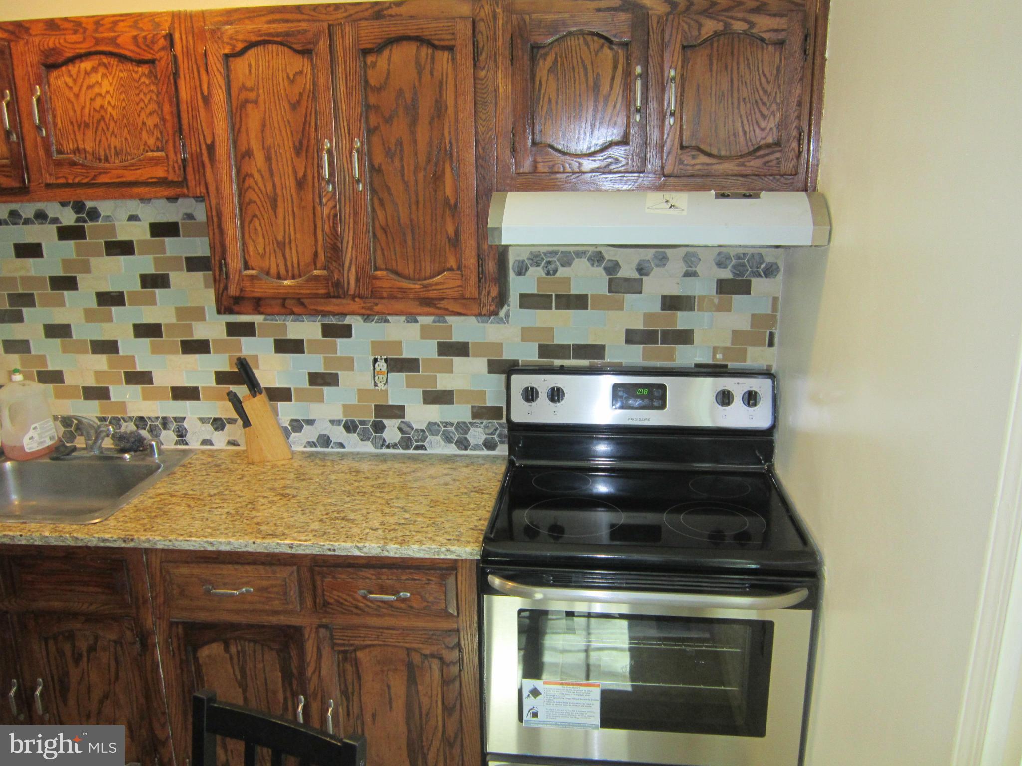 8587 Tyrolean Way Springfield, VA 22153 - Photo 18 of 30 a stove top oven sitting inside of a kitchen