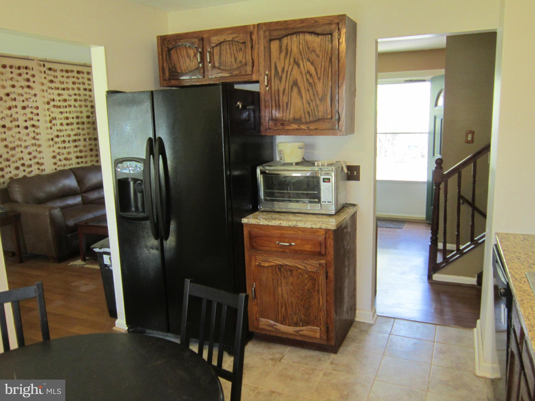 8587 Tyrolean Way Springfield, VA 22153 - Photo 21 of 30 a kitchen with stainless steel appliances granite countertop a refrigerator a stove and a sink