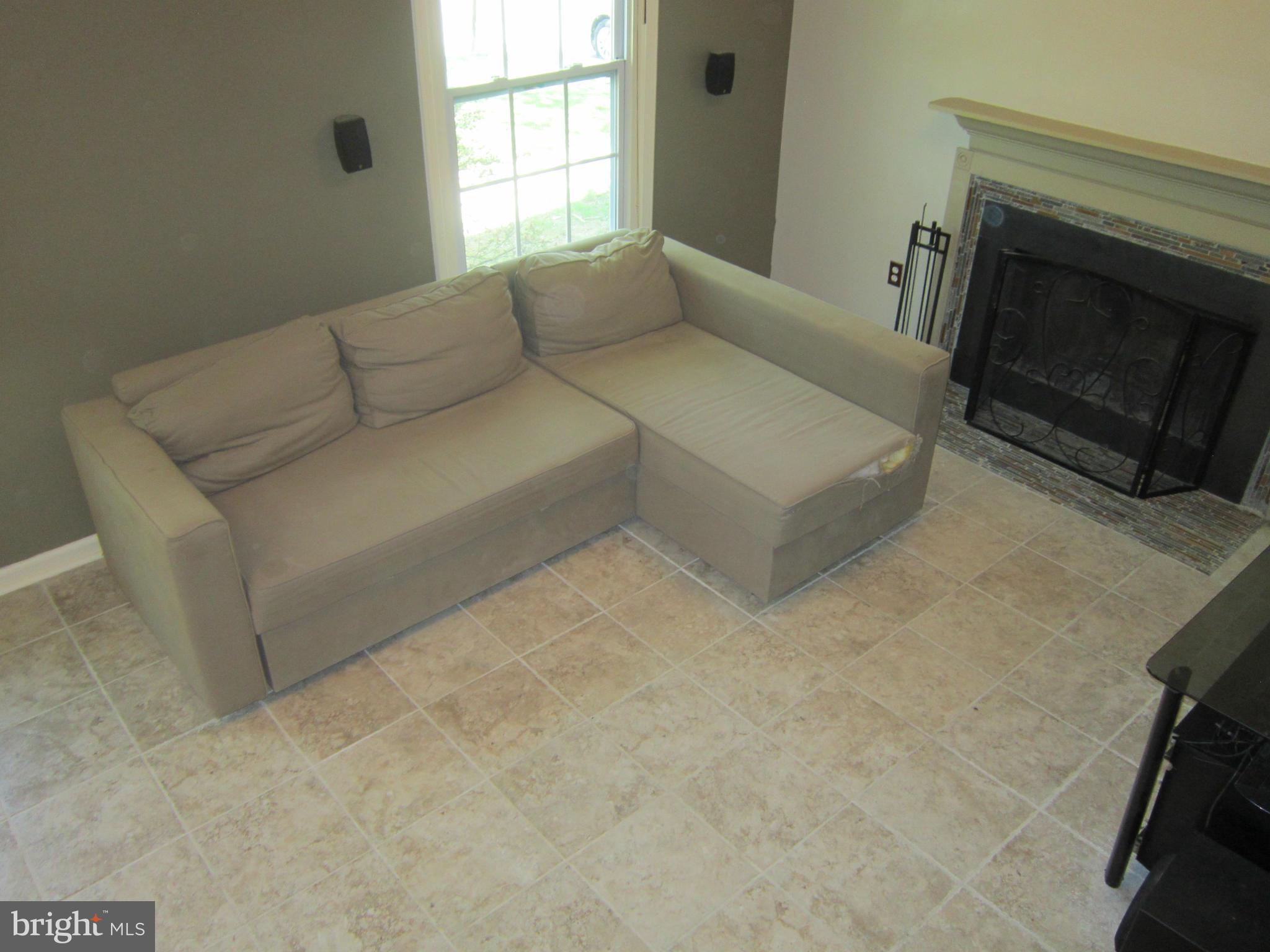 8587 Tyrolean Way Springfield, VA 22153 - Photo 23 of 30 a living room with furniture and a fireplace