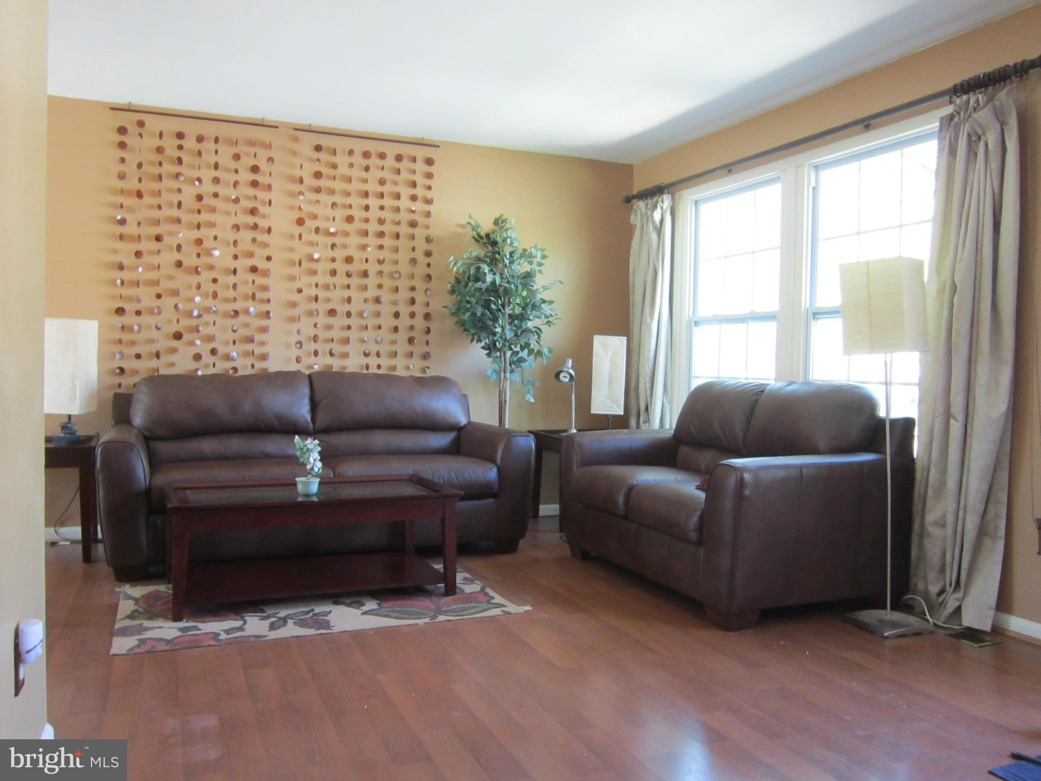 8587 Tyrolean Way Springfield, VA 22153 - Photo 4 of 30 a living room with furniture and a window