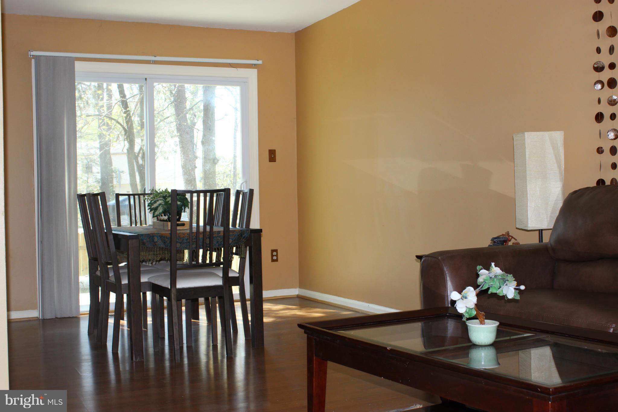 8587 Tyrolean Way Springfield, VA 22153 - Photo 6 of 30 a view of a dining room with furniture window and wooden floor