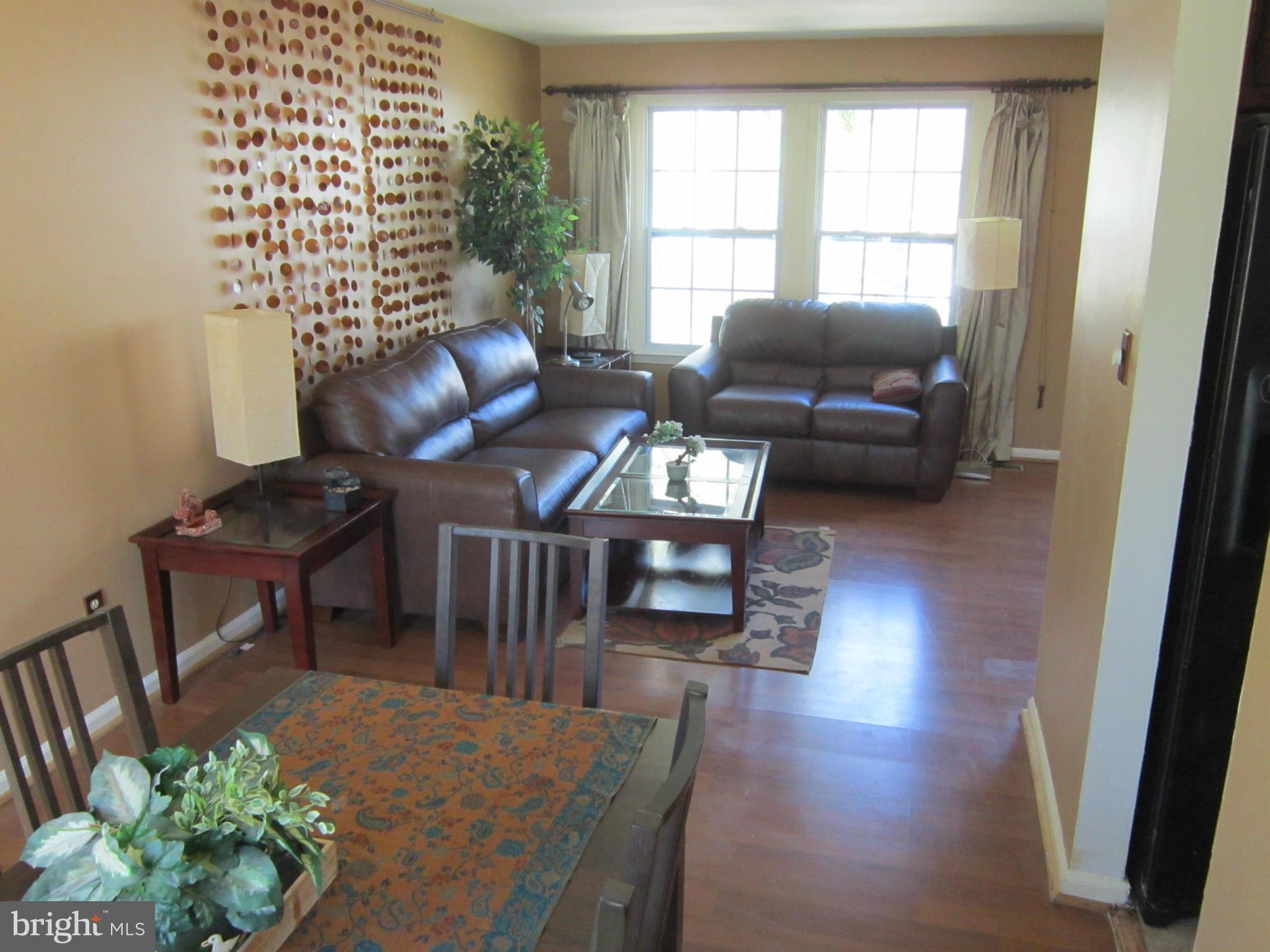 8587 Tyrolean Way Springfield, VA 22153 - Photo 7 of 30 a living room with furniture and a window