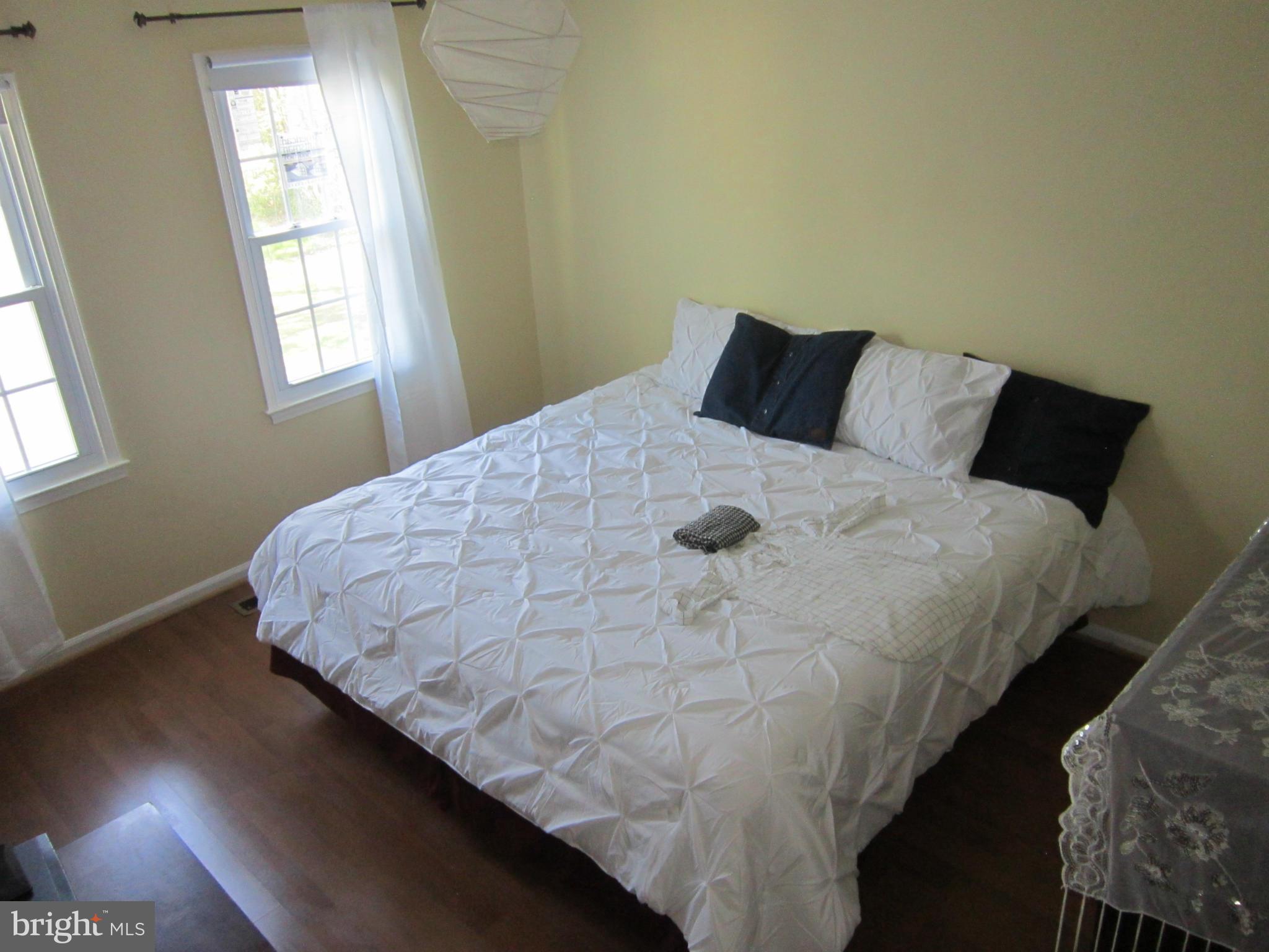 8587 Tyrolean Way Springfield, VA 22153 - Photo 9 of 30 a bed sitting in a bedroom next to a window