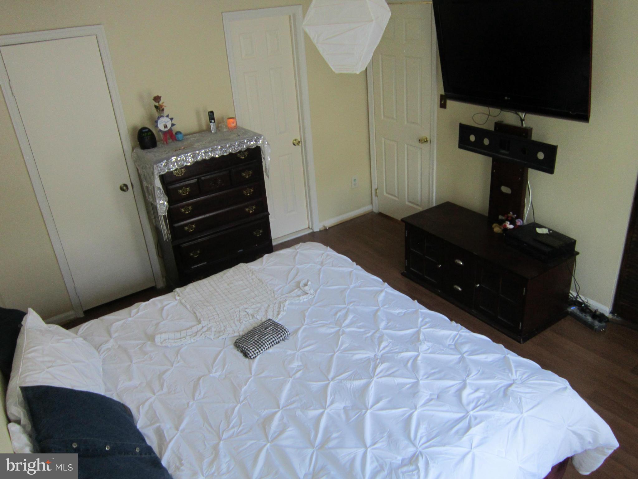 8587 Tyrolean Way Springfield, VA 22153 - Photo 10 of 30 a bedroom with a bed and flat screen tv