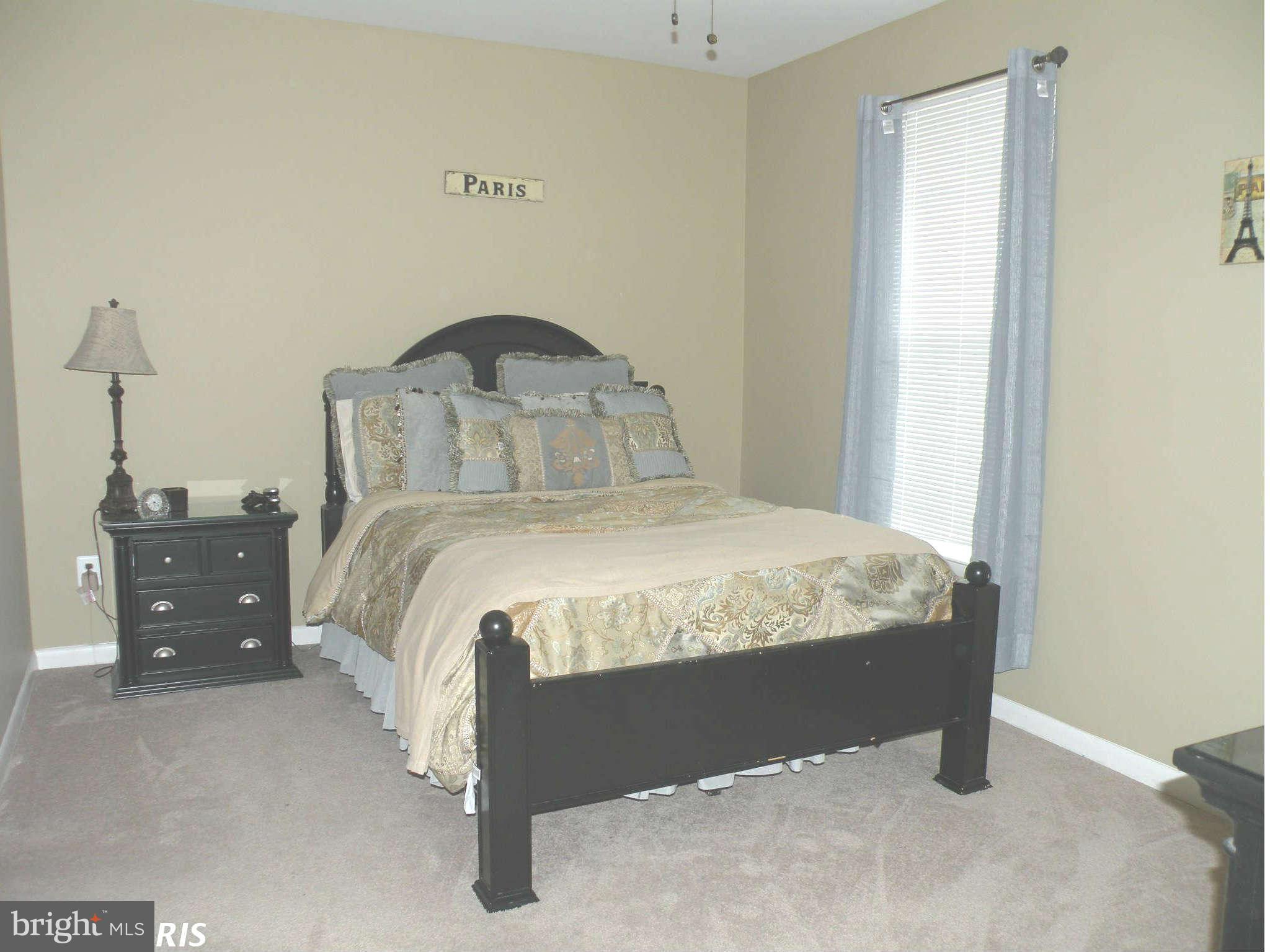 12705 Found Stone Road, Unit 301 Germantown, MD 20876 - Photo 16 of 21 a bedroom with a bed and a dresser