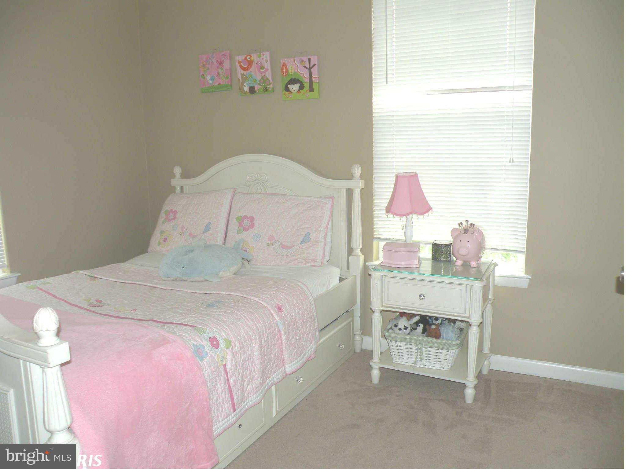 12705 Found Stone Road, Unit 301 Germantown, MD 20876 - Photo 19 of 21 a bedroom with a bed and a dresser