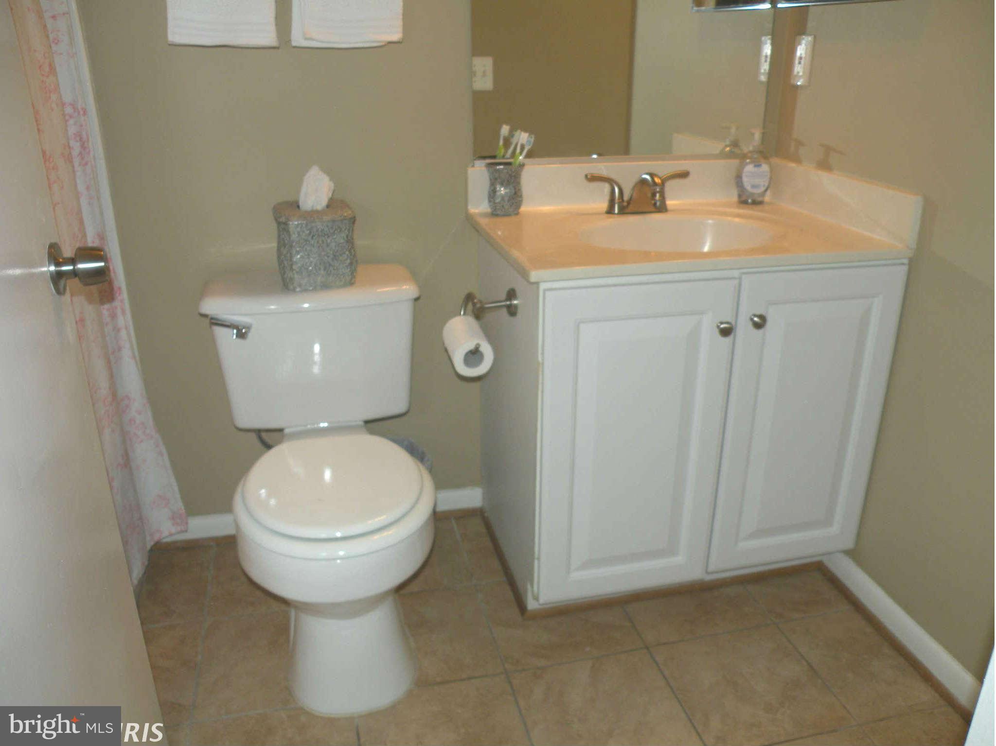 12705 Found Stone Road, Unit 301 Germantown, MD 20876 - Photo 20 of 21 a bathroom with a toilet sink and mirror
