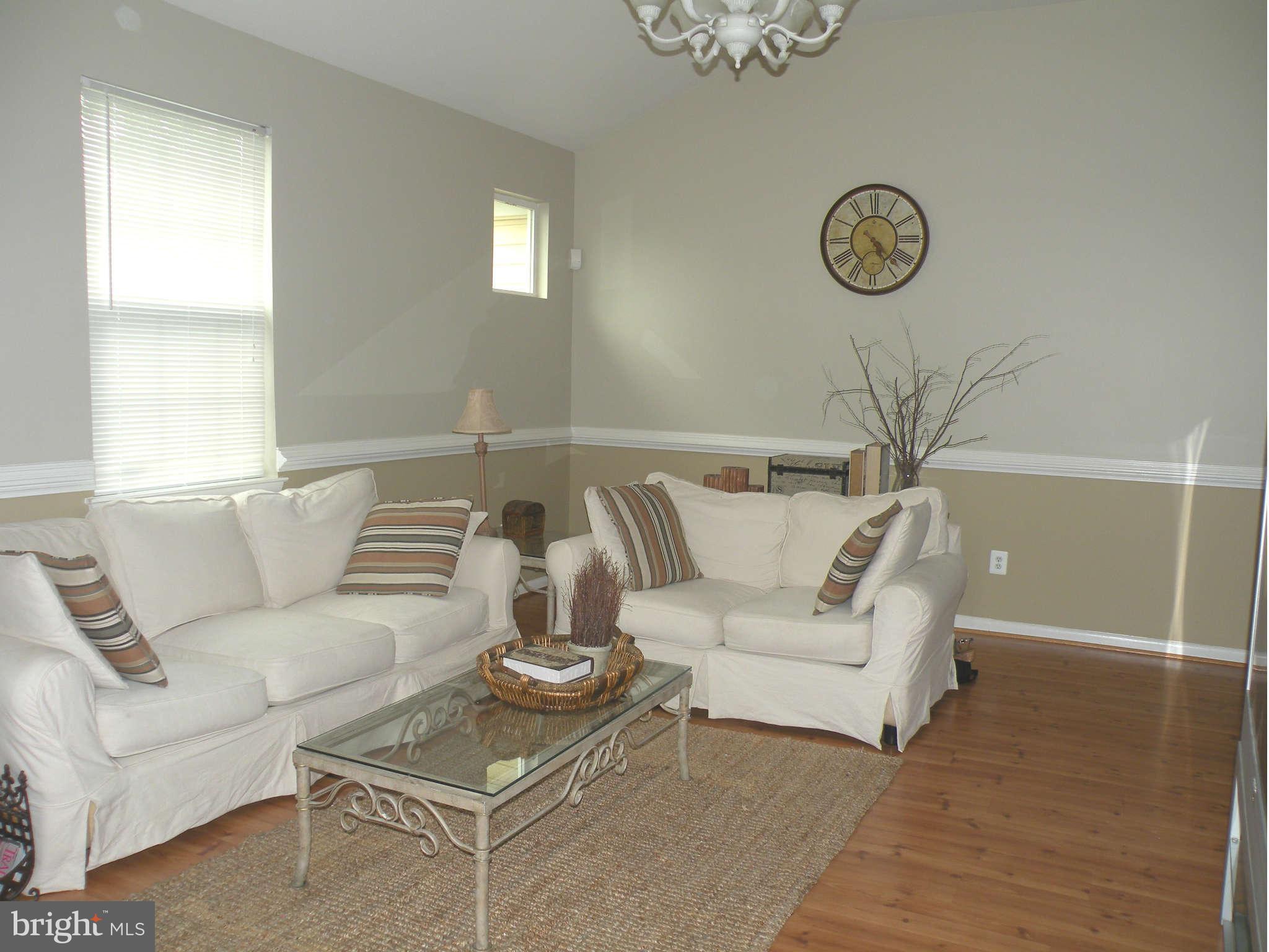 12705 Found Stone Road, Unit 301 Germantown, MD 20876 - Photo 5 of 21 a living room with furniture a couch and a window