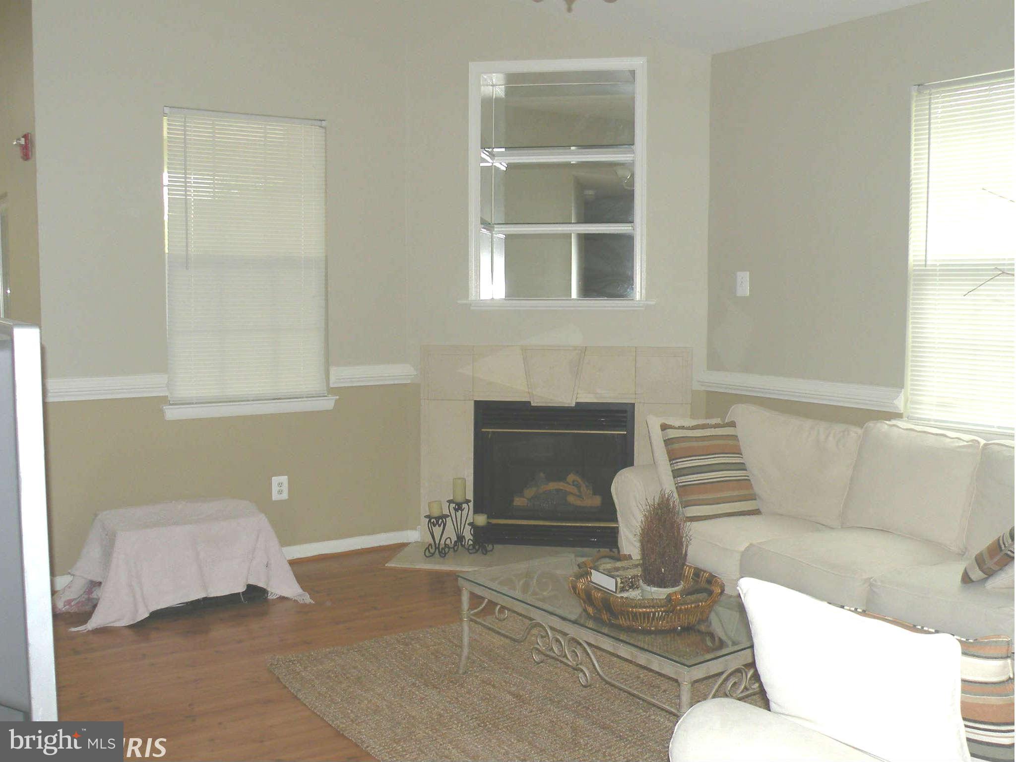 12705 Found Stone Road, Unit 301 Germantown, MD 20876 - Photo 6 of 21 a living room with furniture and a window