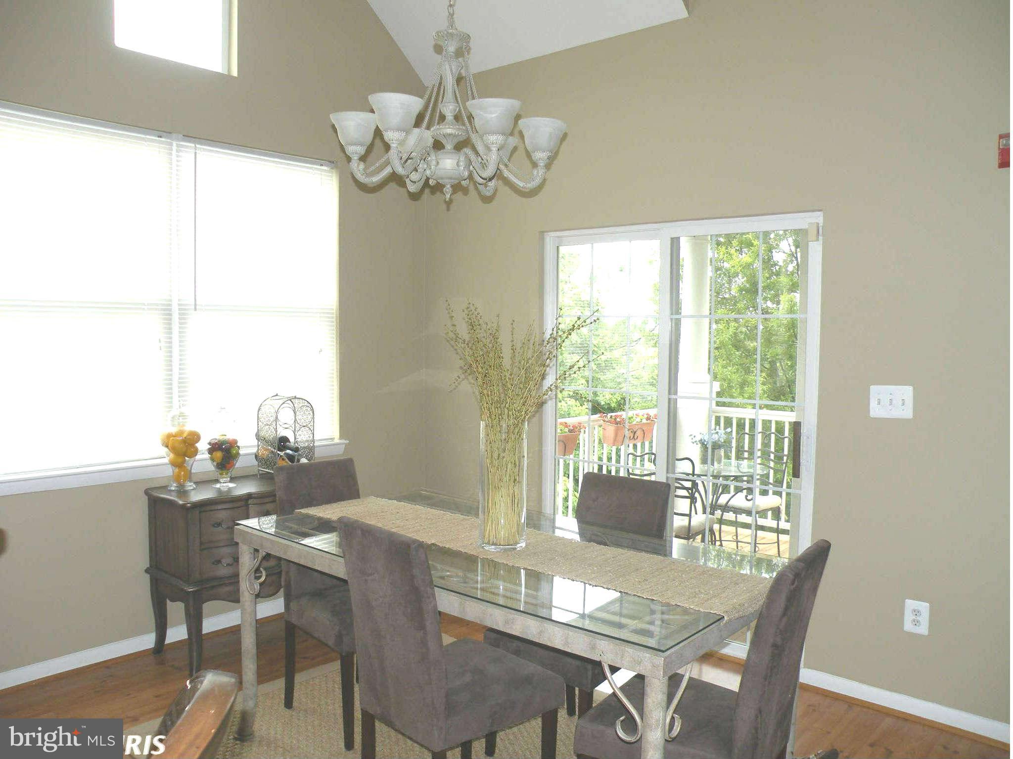 12705 Found Stone Road, Unit 301 Germantown, MD 20876 - Photo 9 of 21 a view of a dining room with furniture a chandelier and wooden floor