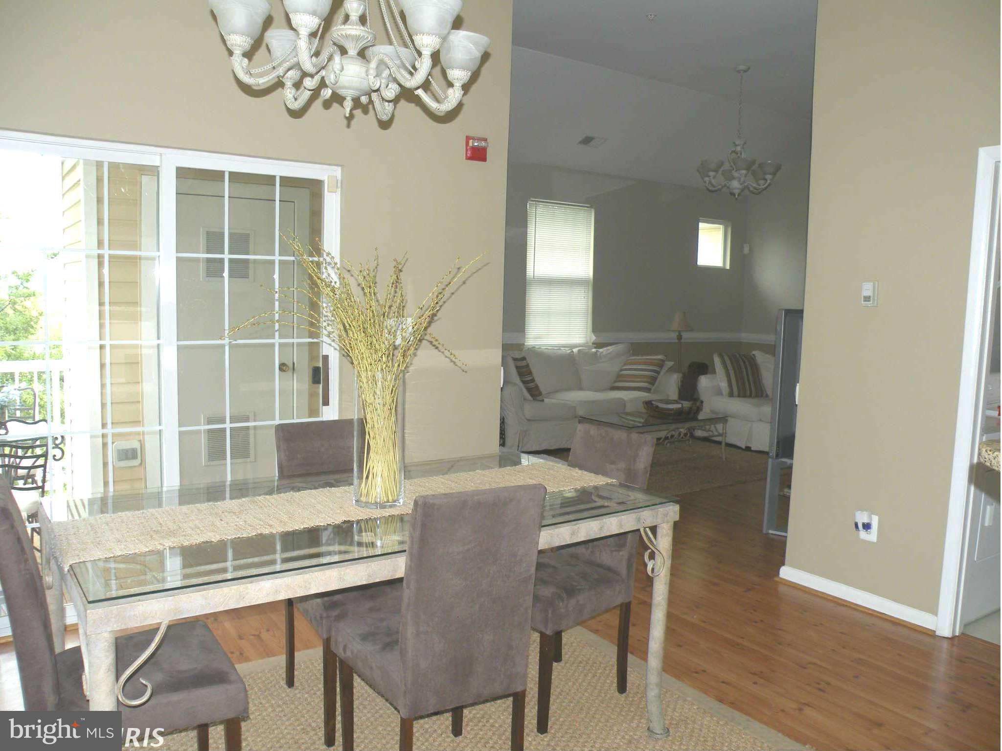 12705 Found Stone Road, Unit 301 Germantown, MD 20876 - Photo 10 of 21 a view of a dining room with furniture and wooden floor