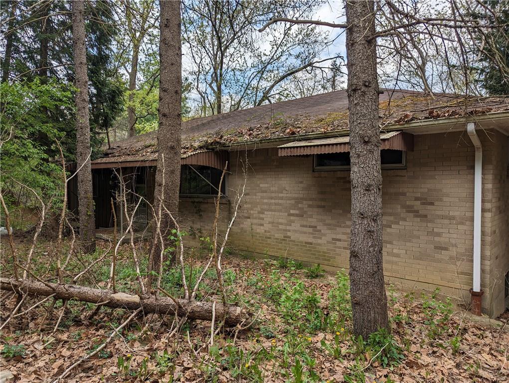 3326 New England Road West Mifflin, PA 15122 - Photo 2 of 12 a backyard of a house with lots of plants and trees