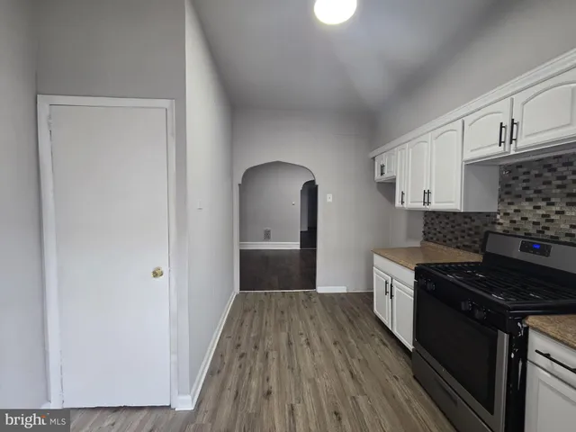 a kitchen with granite countertop a stove and a refrigerator