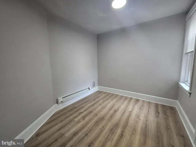 a view of room with window and hardwood floor