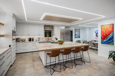 a kitchen with stainless steel appliances kitchen island granite countertop a sink and cabinets