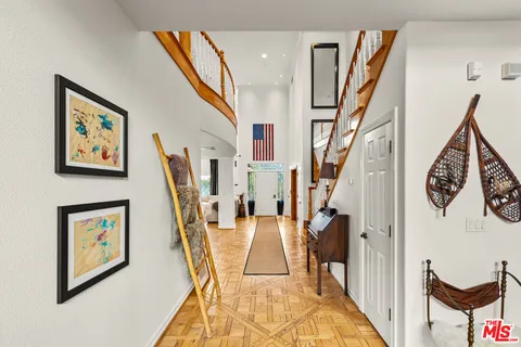 a living room with furniture and a ceiling fan