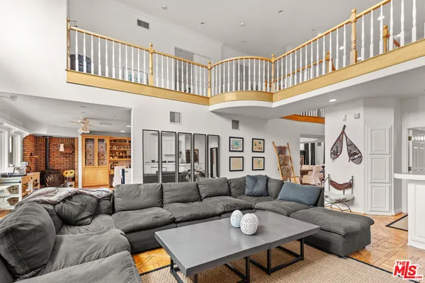 a living room with patio furniture and a chandelier