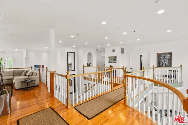 a spacious bedroom with a bed and a chandelier