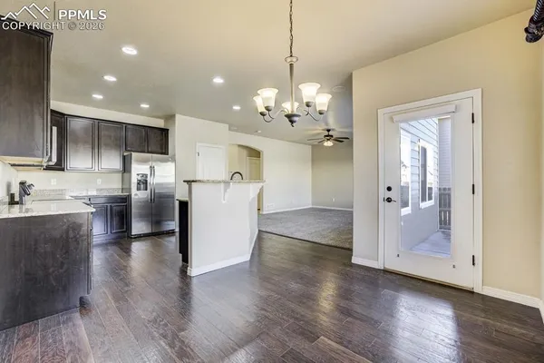 a view of kitchen with stainless steel appliances kitchen island a sink a stove a refrigerator and a window