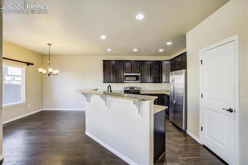 Undisclosed Address Colorado Springs, CO 80925 - Photo 15 of 45 a view of kitchen with stainless steel appliances kitchen island a sink a stove a refrigerator and a window