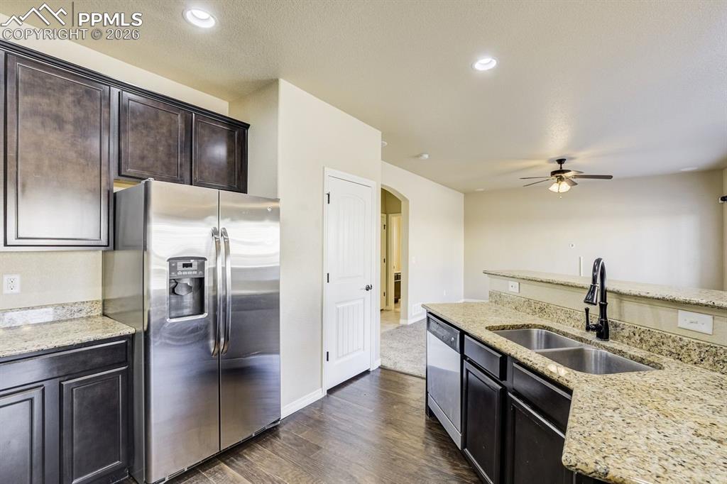 Undisclosed Address Colorado Springs, CO 80925 - Photo 16 of 45 a kitchen with stainless steel appliances granite countertop a refrigerator and a sink