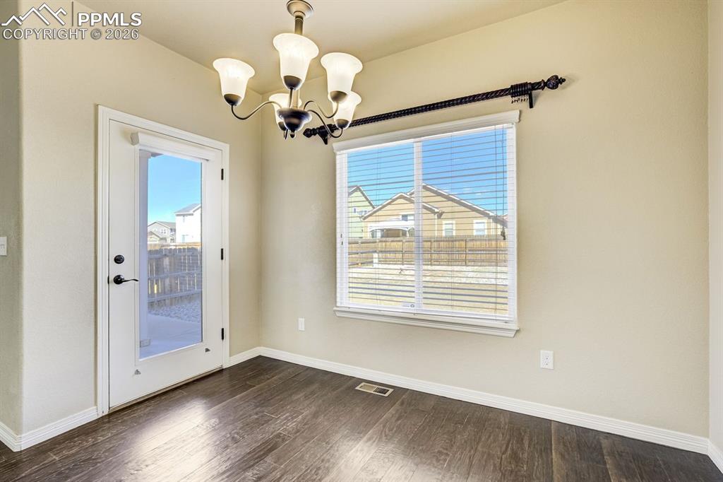 Undisclosed Address Colorado Springs, CO 80925 - Photo 18 of 45 a view of a livingroom with a chandelier fan and windows