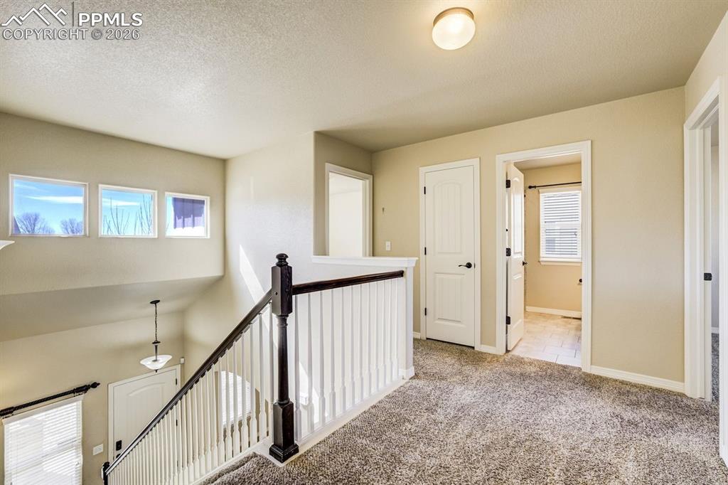 Undisclosed Address Colorado Springs, CO 80925 - Photo 23 of 45 a view of a hallway with entryway to stairs