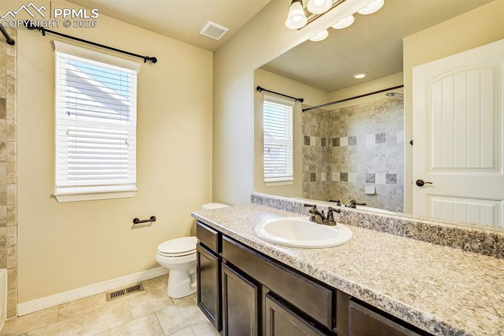 Undisclosed Address Colorado Springs, CO 80925 - Photo 24 of 45 a bathroom with a granite countertop sink toilet and shower