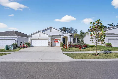 a front view of a house with a yard and garage