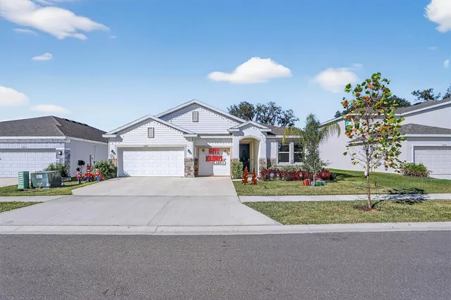 a front view of a house with a yard and garage