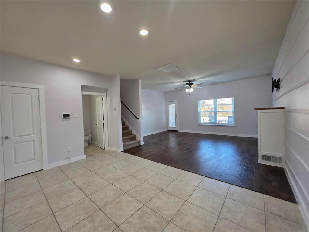 149 Ryan Street Anna, TX 75409 - Photo 3 of 38 an empty room with wooden floor and windows