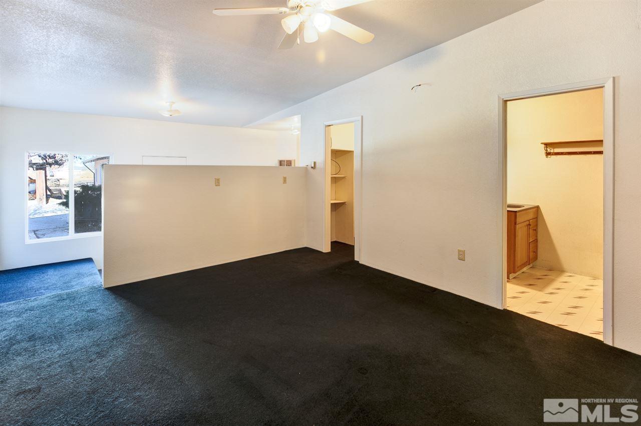 4320 Reno Highway Fallon, NV 89406 - Photo 14 of 28 a view of a room with wooden floor and a ceiling fan
