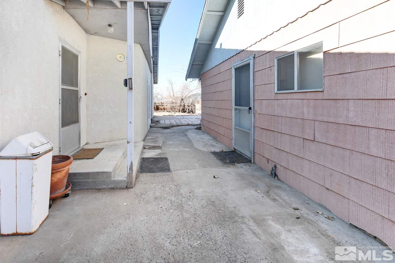 4320 Reno Highway Fallon, NV 89406 - Photo 18 of 28 a view of a porch with couches chairs and wooden floor