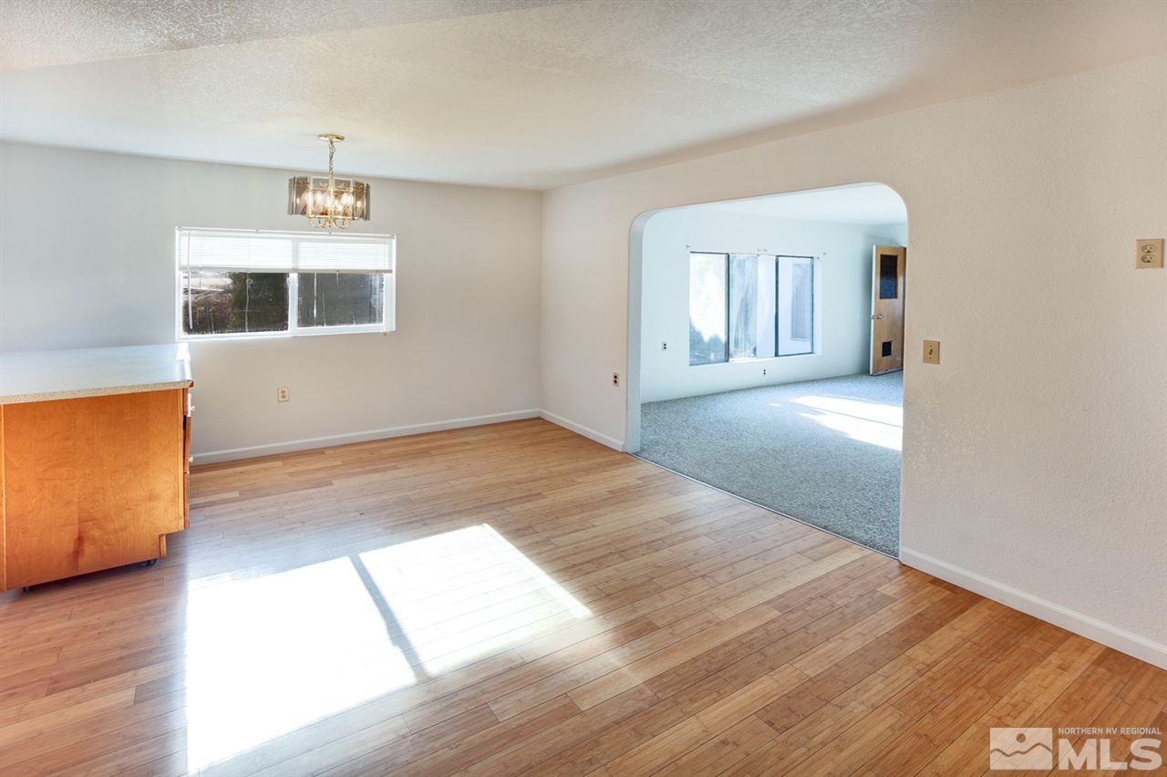 4320 Reno Highway Fallon, NV 89406 - Photo 6 of 28 an empty room with wooden floor and windows