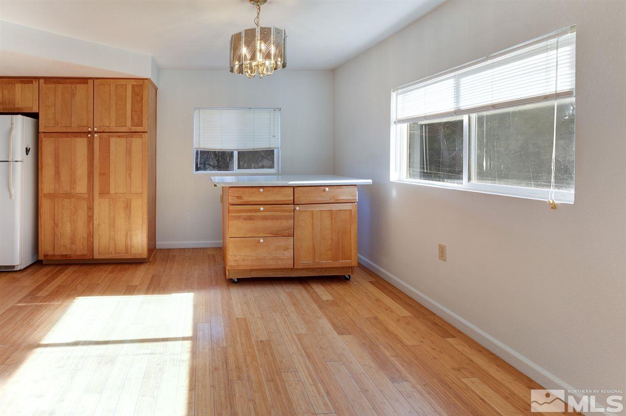 4320 Reno Highway Fallon, NV 89406 - Photo 7 of 28 an empty room with wooden floor cabinet and windows