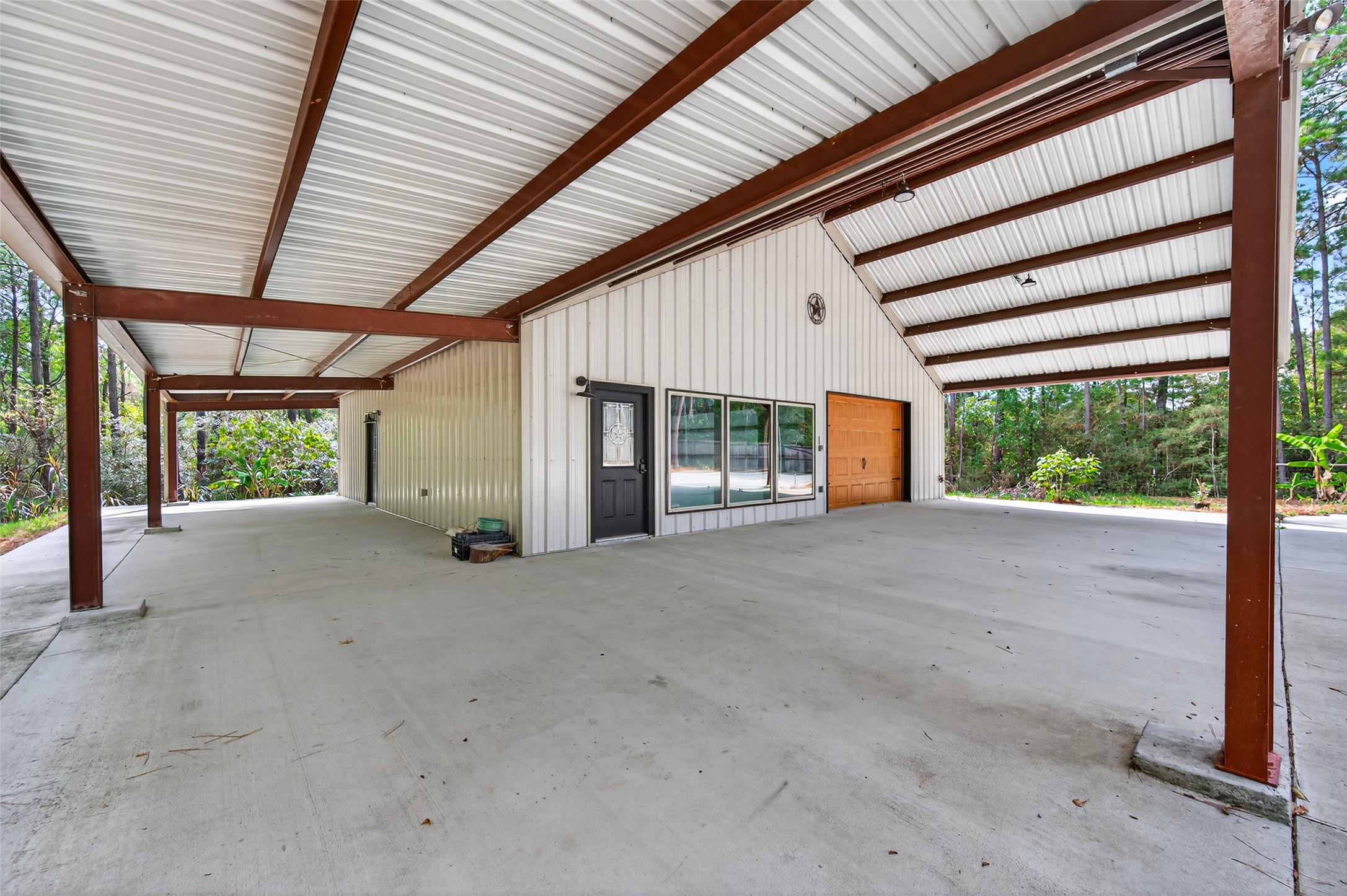 12322 High Fire Road Montgomery, TX 77356 - Photo 36 of 45 Concrete space all the way around the shop and additional coverage for parking!